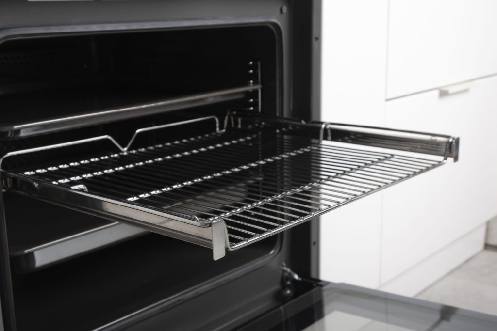 The lit display and touch controls on the fascia of a black built-in oven