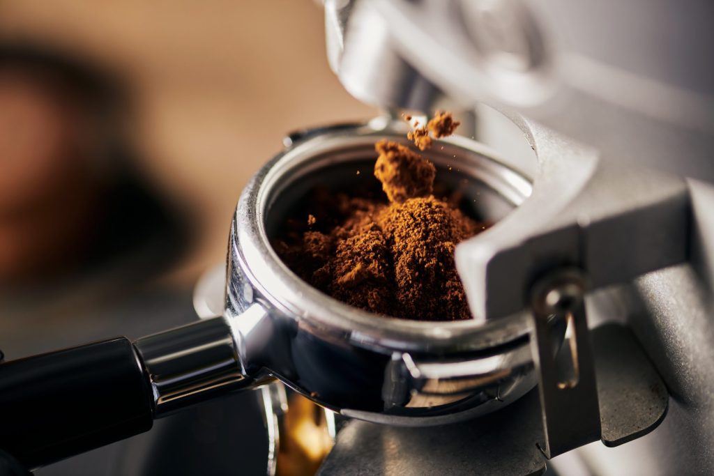 A portafilter filled with freshly ground coffee, close up