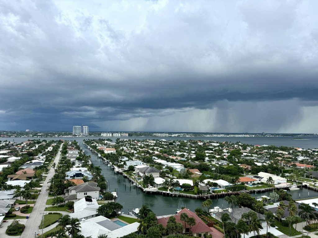 A canal town seen from the air under a rain squall coming in off the water