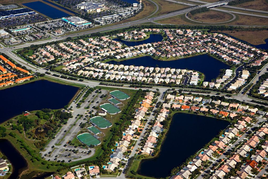 A planned neighborhood laid out around a chain of lakes, from the air