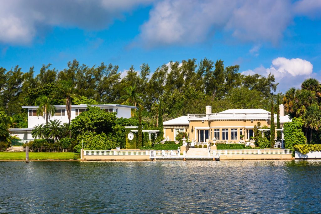 Large houses in mature planting along the far bank of a canal