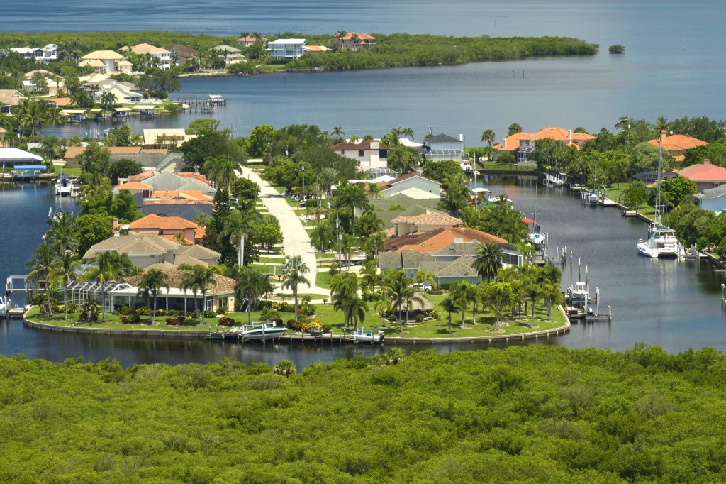 Houses with private docks on a wooded point at the edge of a lagoon