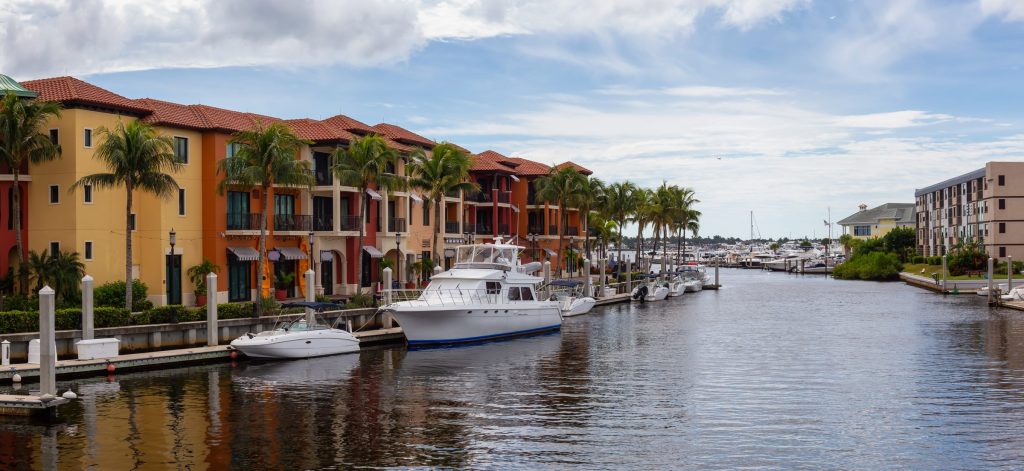 Colored waterfront apartment blocks with yachts moored below them